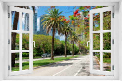 Fototapeta Naklejka Na Ścianę Okno 3D - Road with white lines and median strip with palm trees and grass at Miami, Florida