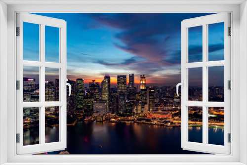 Fototapeta Naklejka Na Ścianę Okno 3D - Southeast Asia, Singapore, November, 2022: Aerial view of Singapore city business skyscrapers and financial district with evening illumination on sunset