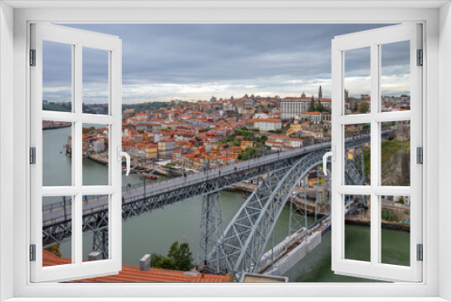  Old town skyline and Dom Luis bridge on the Douro River. Portugal.