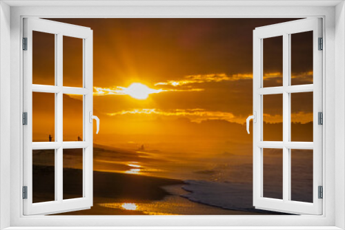 Fototapeta Naklejka Na Ścianę Okno 3D - Sunset on a beach in Spain, with the silhouette of fishermen and orange and yellow colors.