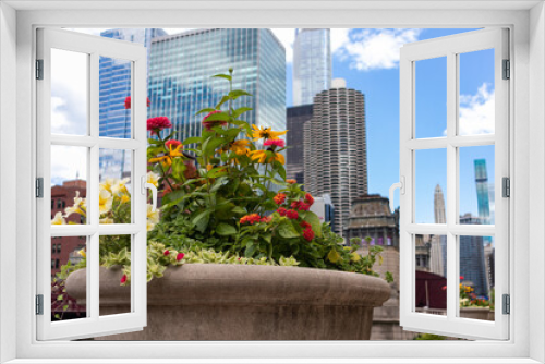 Fototapeta Naklejka Na Ścianę Okno 3D - Beautiful Flower Pot with Colorful Flowers along the Chicago River in Downtown Chicago during the Summer with Skyscrapers