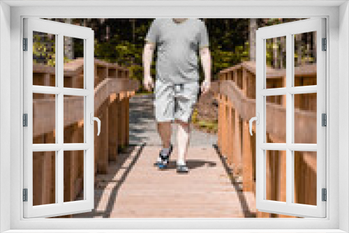 person walking on a wooden bridge