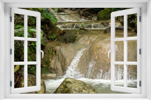 Fototapeta Naklejka Na Ścianę Okno 3D - Enchanting waterfall with gentle flowing water on a big rock