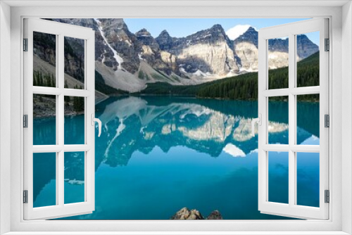 Fototapeta Naklejka Na Ścianę Okno 3D - Moraine Lake is a stunningly beautiful lake located in Banff National Park, Alberta, Canada. The lake is known for its vibrant blue waters and the towering peaks of the Canadian Rockies.