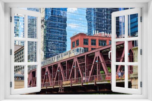 Fototapeta Naklejka Na Ścianę Okno 3D - Travel train in Chicago going over bridge by skyscrapers