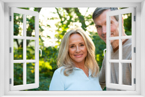 Portrait of middle-aged heterosexual couple posing outdoors