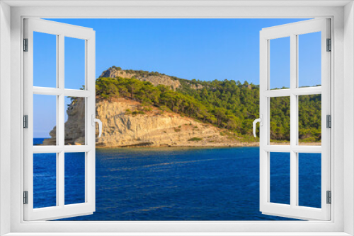 Fototapeta Naklejka Na Ścianę Okno 3D - View of the rocky shore from the sea. Mediterranean Sea in Turkey. Popular tourist places. Background