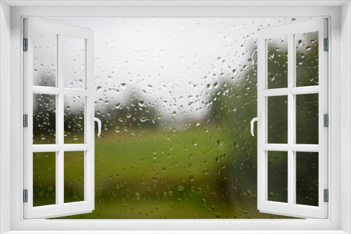 Fototapeta Naklejka Na Ścianę Okno 3D - Waterdrops on window informs of nature landscape 