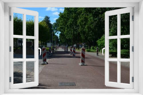 Fototapeta Naklejka Na Ścianę Okno 3D - Striped road warning posts on city street