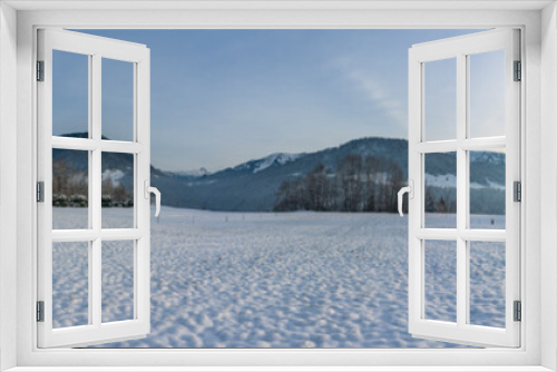Fototapeta Naklejka Na Ścianę Okno 3D - Panorama von Hittisau, mit einem Holzstadel auf der verschneiten Wiese