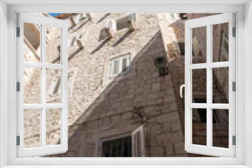 Fototapeta Naklejka Na Ścianę Okno 3D - Old medieval wall with wooden window shutters in Split in Croatia
