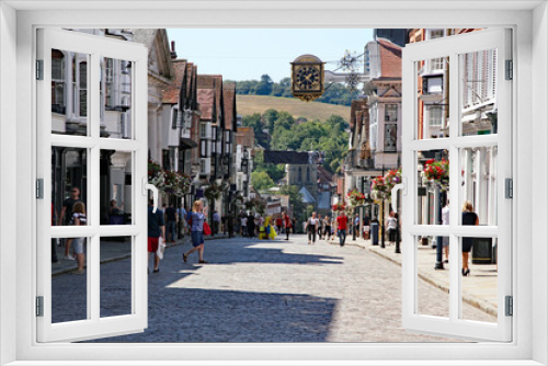 Fototapeta Naklejka Na Ścianę Okno 3D - Guildford’s cobbled high street bustling with anonymised shops and shoppers