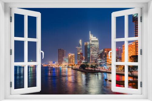 Fototapeta Naklejka Na Ścianę Okno 3D - Ho Chi Minh City, Vietnam - December 26, 2022: Beautiful night in Ho Chi Minh city known as Saigon, one of the big cities is developed in Vietnam. See Bitexco tower, saigon river and center city view 