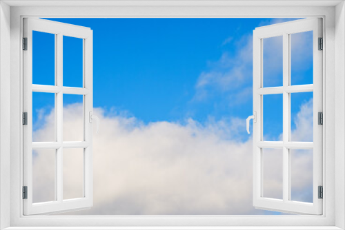 White fluffy soft clouds against a blue sky