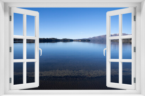 Fototapeta Naklejka Na Ścianę Okno 3D - View of the lake, forest and mountains in a sunny day with a deep blue sky. 