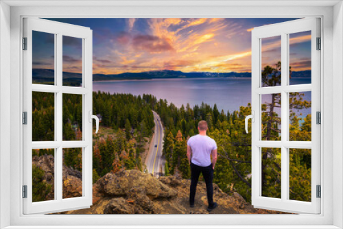 Fototapeta Naklejka Na Ścianę Okno 3D - Hiker enjoying sunset over Lake Tahoe from the Eagle Rock in California