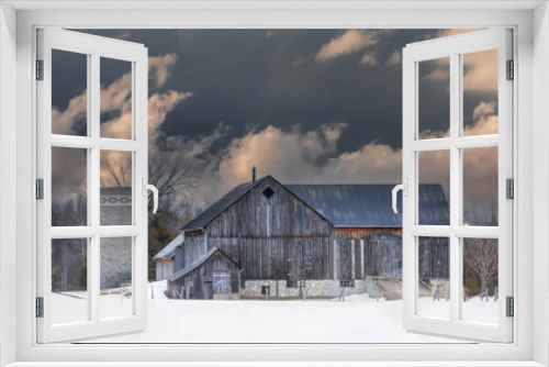 Fototapeta Naklejka Na Ścianę Okno 3D - Weathered and rusted wooden barn on a cold snowy day in winter near Dunrobin, Canada