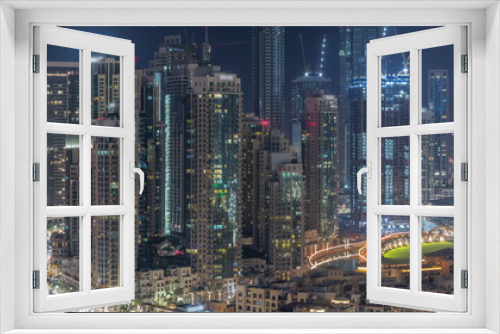 Fototapeta Naklejka Na Ścianę Okno 3D - Futuristic aerial all night cityscape timelapse with illuminated architecture of Dubai downtown, United Arab Emirates.