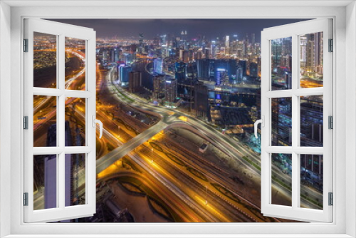 Fototapeta Naklejka Na Ścianę Okno 3D - Panorama showing skyline of Dubai with business bay and downtown district night timelapse.