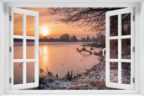 Fototapeta Naklejka Na Ścianę Okno 3D - Krajobraz zimowy. Widok ze wschodem słońca i zimowy poranek nad rzeką. Zamrożona rzeka. Świtanie w zimowej scenerii. Mroźny poranek. Tło natury.	