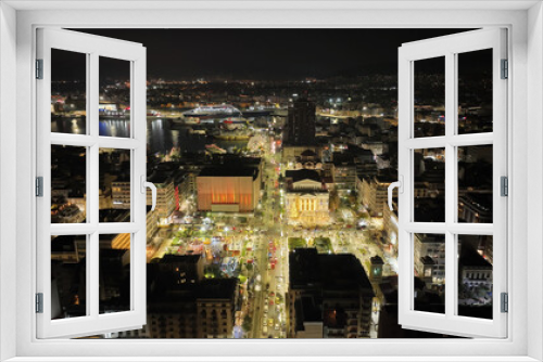 Fototapeta Naklejka Na Ścianę Okno 3D - Aerial drone night shot of famous neoclassic Municipal Theatre of Piraeus and recently renovated main square illuminated during Christmas period, Attica, Greece