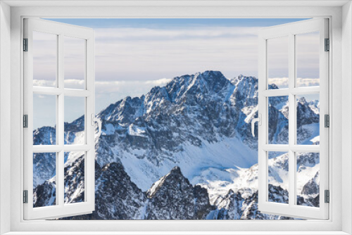 Fototapeta Naklejka Na Ścianę Okno 3D - Snowy winter high mountain landscape. A panoramic view from the top of The Lomnicky peak in High Tatras National Park, Slovakia, Europe.