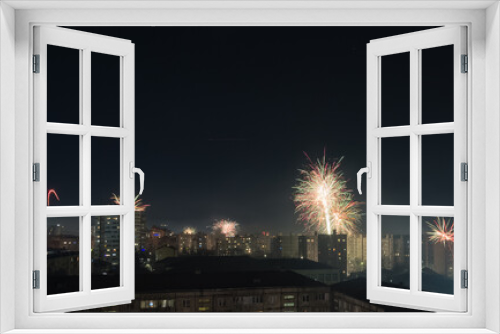 Fototapeta Naklejka Na Ścianę Okno 3D - Bright colorful and multi-colored fireworks on New Year's Eve over the city, fireworks explode over a residential city