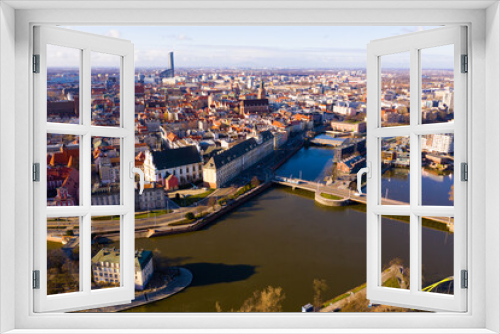 Fototapeta Naklejka Na Ścianę Okno 3D - Picturesque aerial view of Wroclaw on Oder River bank overlooking historical Market Square with Old Town Hall, massive Gothic church of St. Elizabeth and St. Mary Magdalene Church in spring, Poland