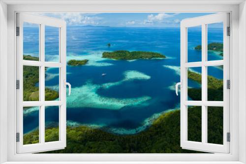 Fototapeta Naklejka Na Ścianę Okno 3D - Extensive coral reefs fringe rainforest-covered islands in the Solomon Islands. This beautiful country is home to spectacular marine biodiversity and many historic WWII sites.