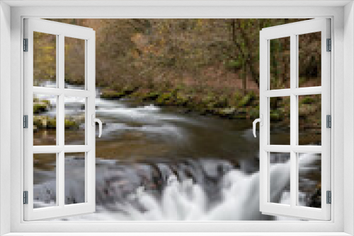 Fototapeta Naklejka Na Ścianę Okno 3D - Long exposure of the Watersmeet Bridge waterfall at Watersmeet in Exmoor National Park