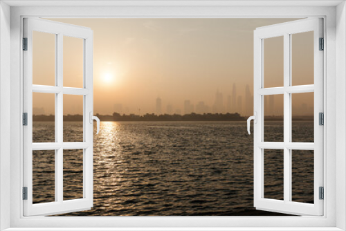 Fototapeta Naklejka Na Ścianę Okno 3D - The view from Palm Jumeirah Beach to the city limits. Bright sunrise, sunshine in the frame. 