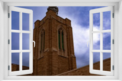 Fototapeta Naklejka Na Ścianę Okno 3D - Church building on the city street and dramatic cloudscape, the First Baptist Church in Odessa, Texas, USA