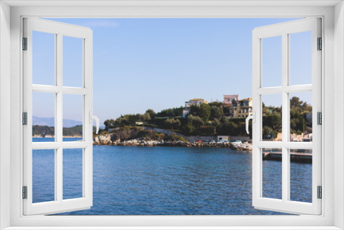 Fototapeta Naklejka Na Ścianę Okno 3D - Aerial view of Kassiopi, village in northeast coast of Corfu island, Ionian Islands, Kerkyra, Greece in a summer sunny day, with marina, town, beach and castle