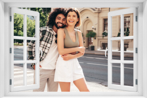 Smiling beautiful woman and her handsome boyfriend. Sexy cheerful family having tender moments in the street at sunset. Models hugging. Embracing each other. Love concept. Cheerful and happy