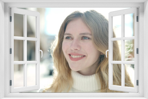 Young blonde woman smiling confident looking to the side at street