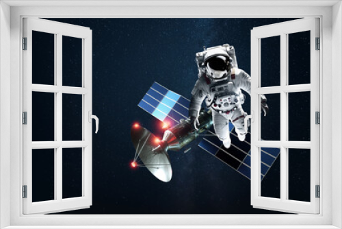 Fototapeta Naklejka Na Ścianę Okno 3D - Astronaut in a white spacesuit in space on the background of a satellite. Exploration of space and other planets, colonization of the solar system. Copy space, 3D illustration, 3D renderer.