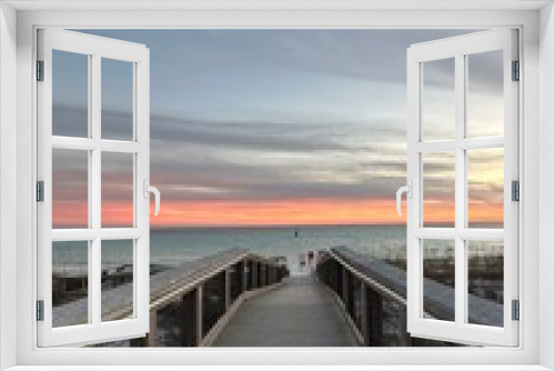 Fototapeta Naklejka Na Ścianę Okno 3D - Walkway with sunset sky background over the Gulf of Mexico Emerald Coast Florida 