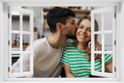 Man is kissing his girlfriend on the cheek