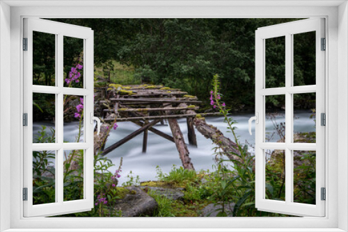 Fototapeta Naklejka Na Ścianę Okno 3D - Brücke über tosenden Fluss