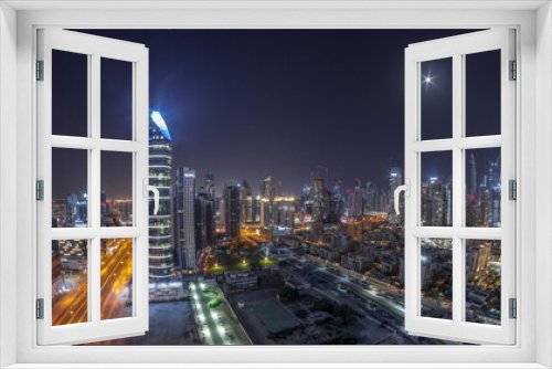 Fototapeta Naklejka Na Ścianę Okno 3D - Dubai's business bay towers aerial all night . Rooftop view of some skyscrapers