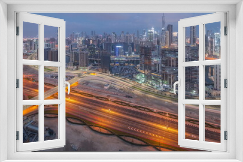Fototapeta Naklejka Na Ścianę Okno 3D - Panoramic skyline of Dubai with business bay and downtown district night to day .