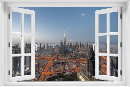 Fototapeta Naklejka Na Ścianę Okno 3D - Aerial view of tallest towers in Dubai Downtown skyline and highway night to day .