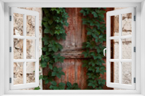 Fototapeta Naklejka Na Ścianę Okno 3D - Abandoned wooden door in an ancient stone building
