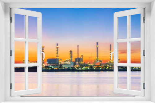 Fototapeta Naklejka Na Ścianę Okno 3D - Panorama of oil refinery with reflection, petrochemical plant.Gas refinery beside river.Colorful twilight at sunrise time.Slow speed shutter made motion blur.Water pollution from industry may concern.