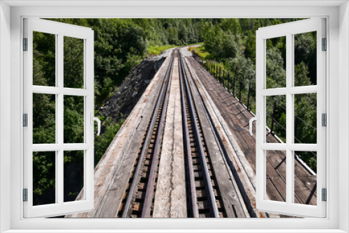 Fototapeta Naklejka Na Ścianę Okno 3D - Long empty railroad track rails through the forest parks in Alaska
