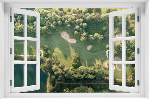 Fototapeta Naklejka Na Ścianę Okno 3D - Landscape in golf course and water in lake or lakeside in aerial view. Include green field, lawn, grass. Design for golfers to play game, sport, outdoor recreation activity.