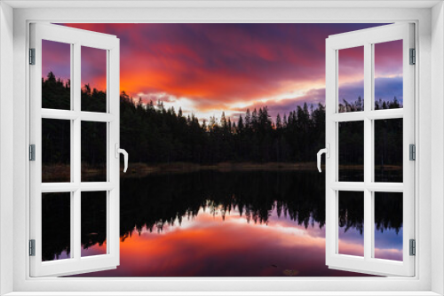 Fototapeta Naklejka Na Ścianę Okno 3D - Forest reflection in still lake at sunset