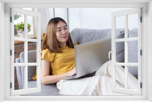 Woman Using Laptop on Sofa