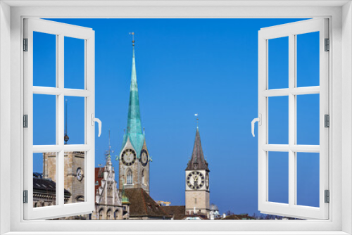 Fototapeta Naklejka Na Ścianę Okno 3D - Scenic view of Limmat River with churches and the skyline of the old town of City of Zürich on a sunny winter day. Photo taken February 9th, 2023, Zurich, Switzerland.