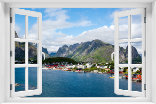 Fototapeta Naklejka Na Ścianę Okno 3D - View of a fishing village from a fjord in the Lofoten Islands. Reine. Red Scandinavian houses on the shore of the fjord
